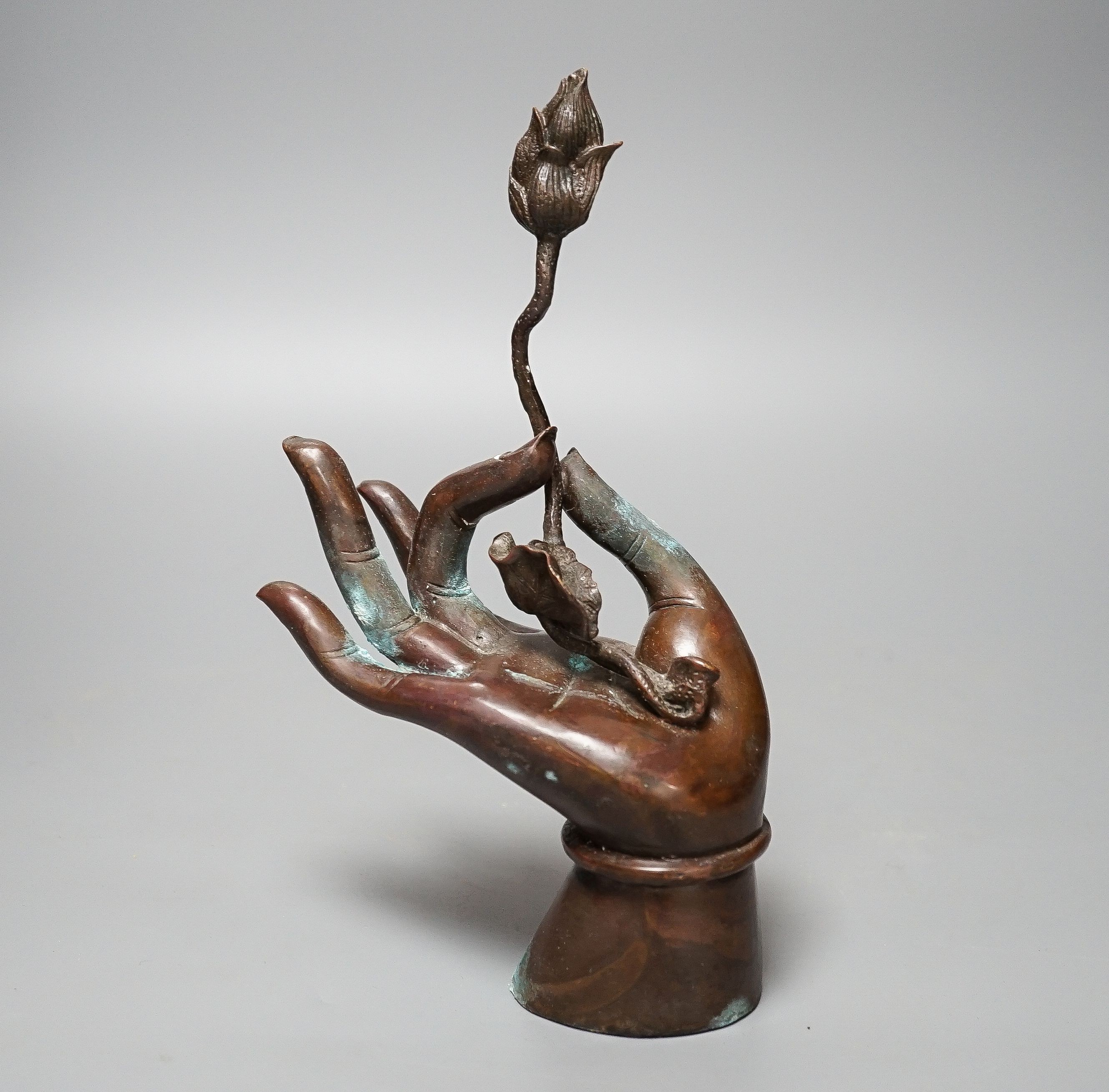 A Himalyan bronze Bodhisattva’s hand, holding a lotus flower 22cm